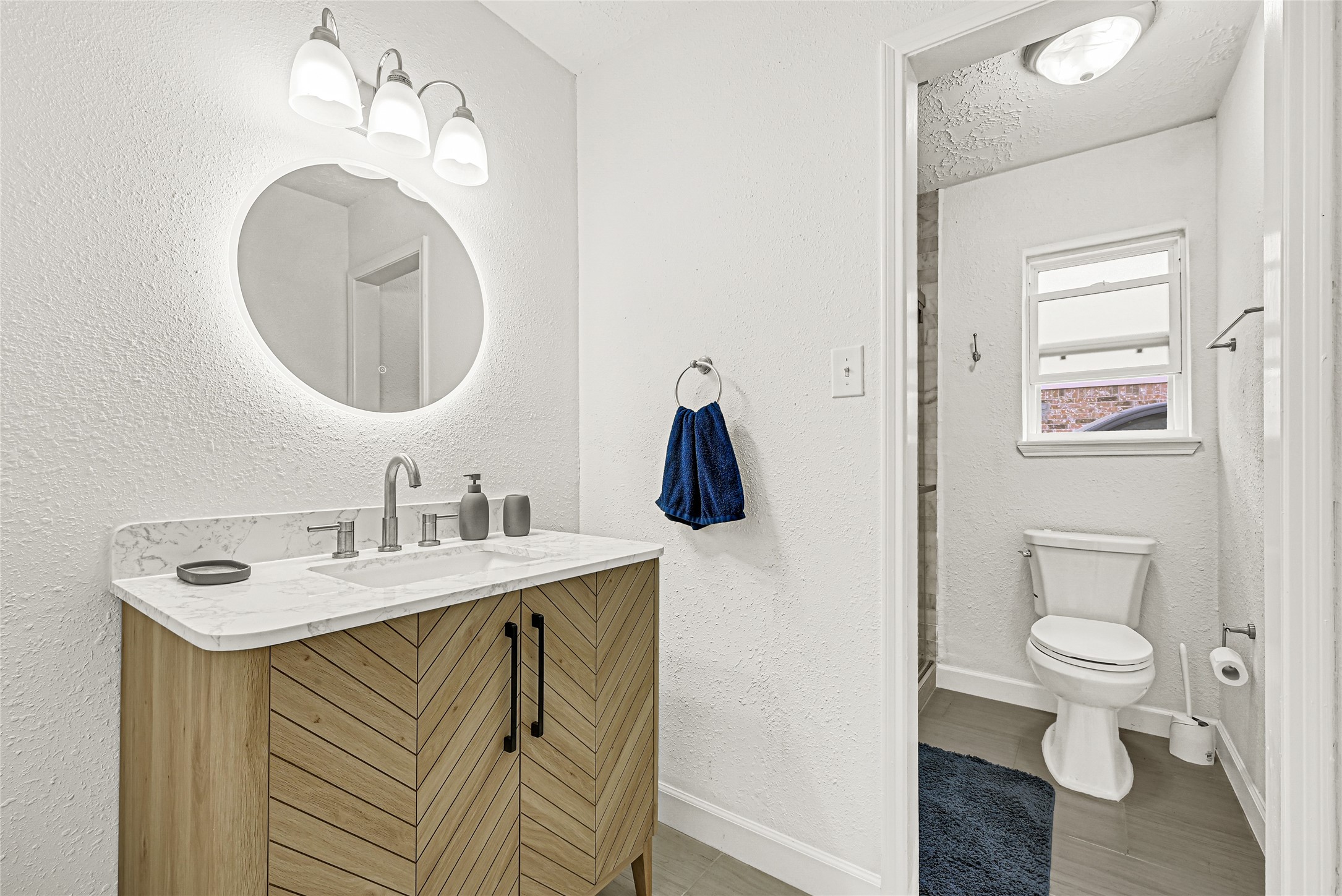 2407 Rambling Brook Drive Spring, TX 77373 - Photo 12 of 49 a bathroom with a toilet sink vanity and mirror