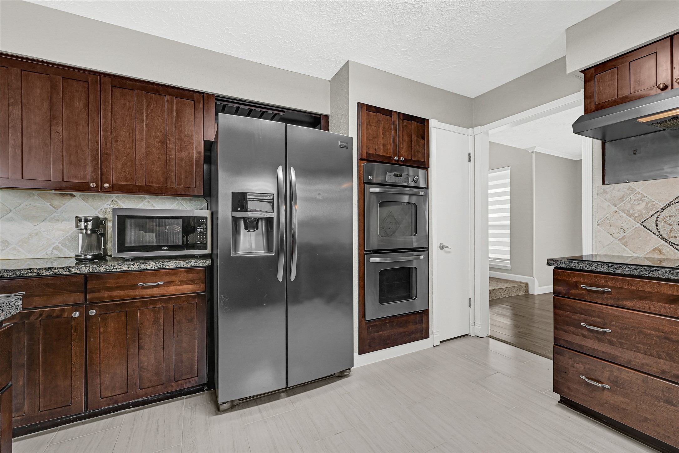 2407 Rambling Brook Drive Spring, TX 77373 - Photo 2 of 49 a kitchen with stainless steel appliances granite countertop a refrigerator and a stove top oven