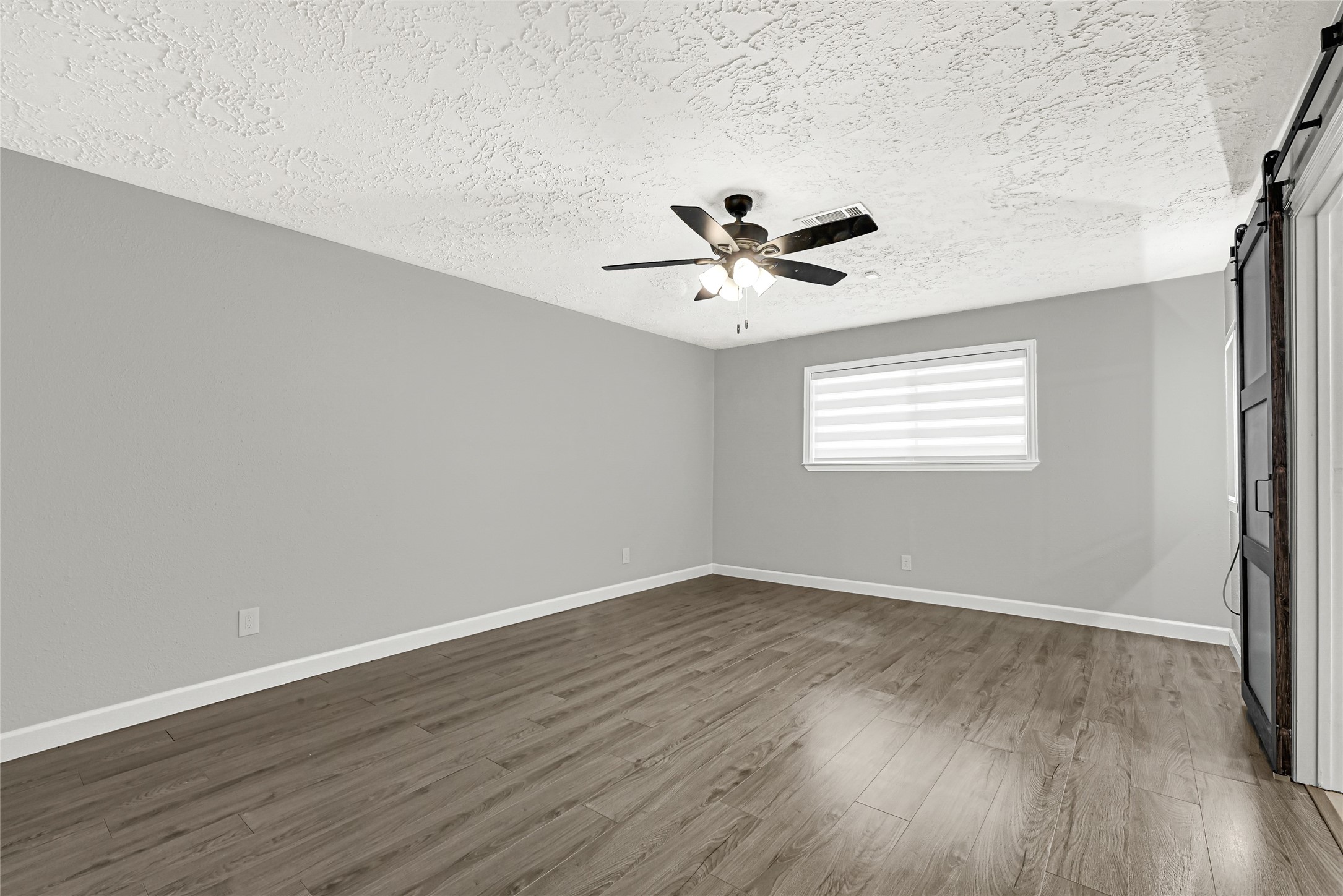2407 Rambling Brook Drive Spring, TX 77373 - Photo 24 of 49 an empty room with wooden floor and windows