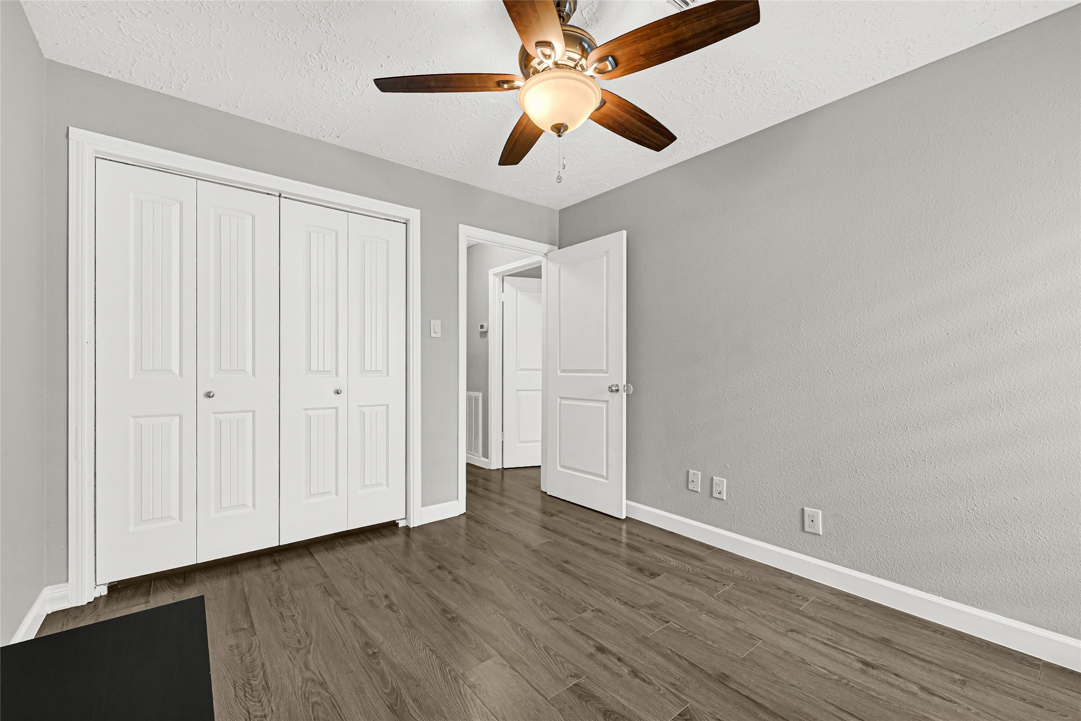 2407 Rambling Brook Drive Spring, TX 77373 - Photo 28 of 49 an empty room with wooden floor fan and windows