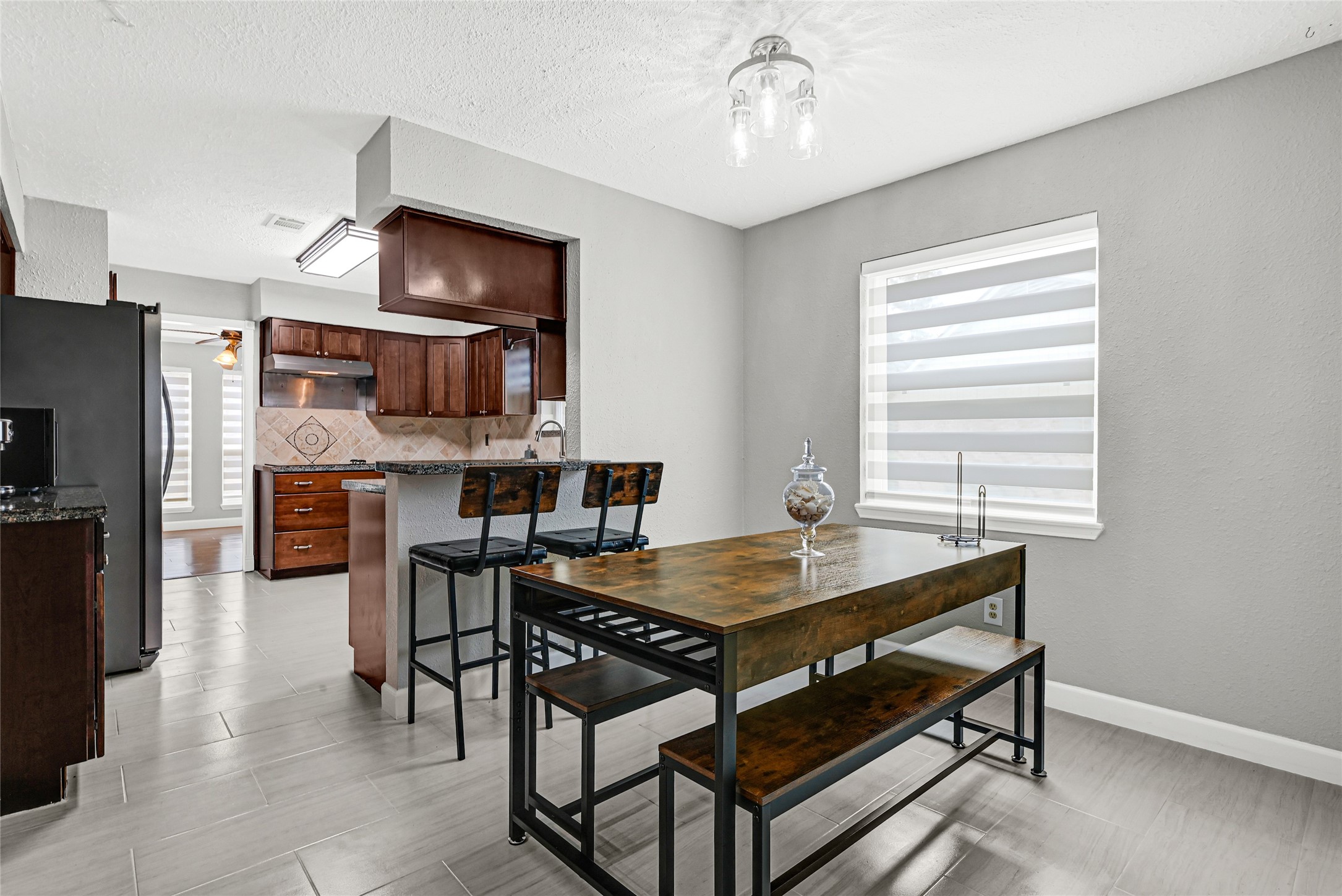2407 Rambling Brook Drive Spring, TX 77373 - Photo 33 of 49 a dining room with a table chairs and a kitchen view