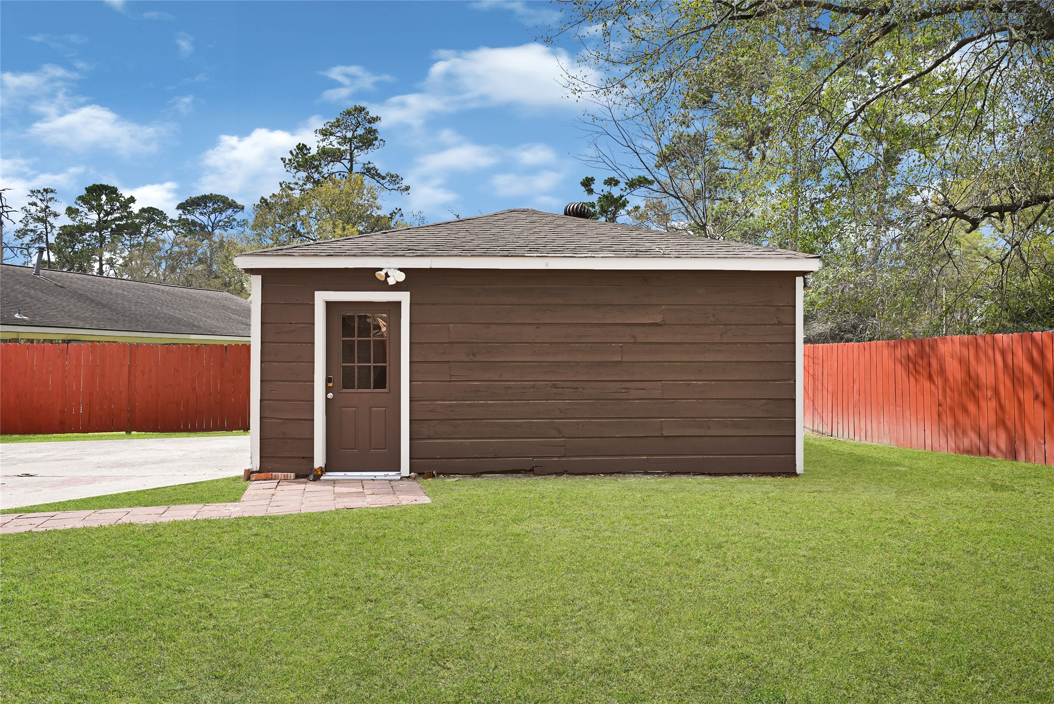 2407 Rambling Brook Drive Spring, TX 77373 - Photo 45 of 49 a front view of a house with a garden