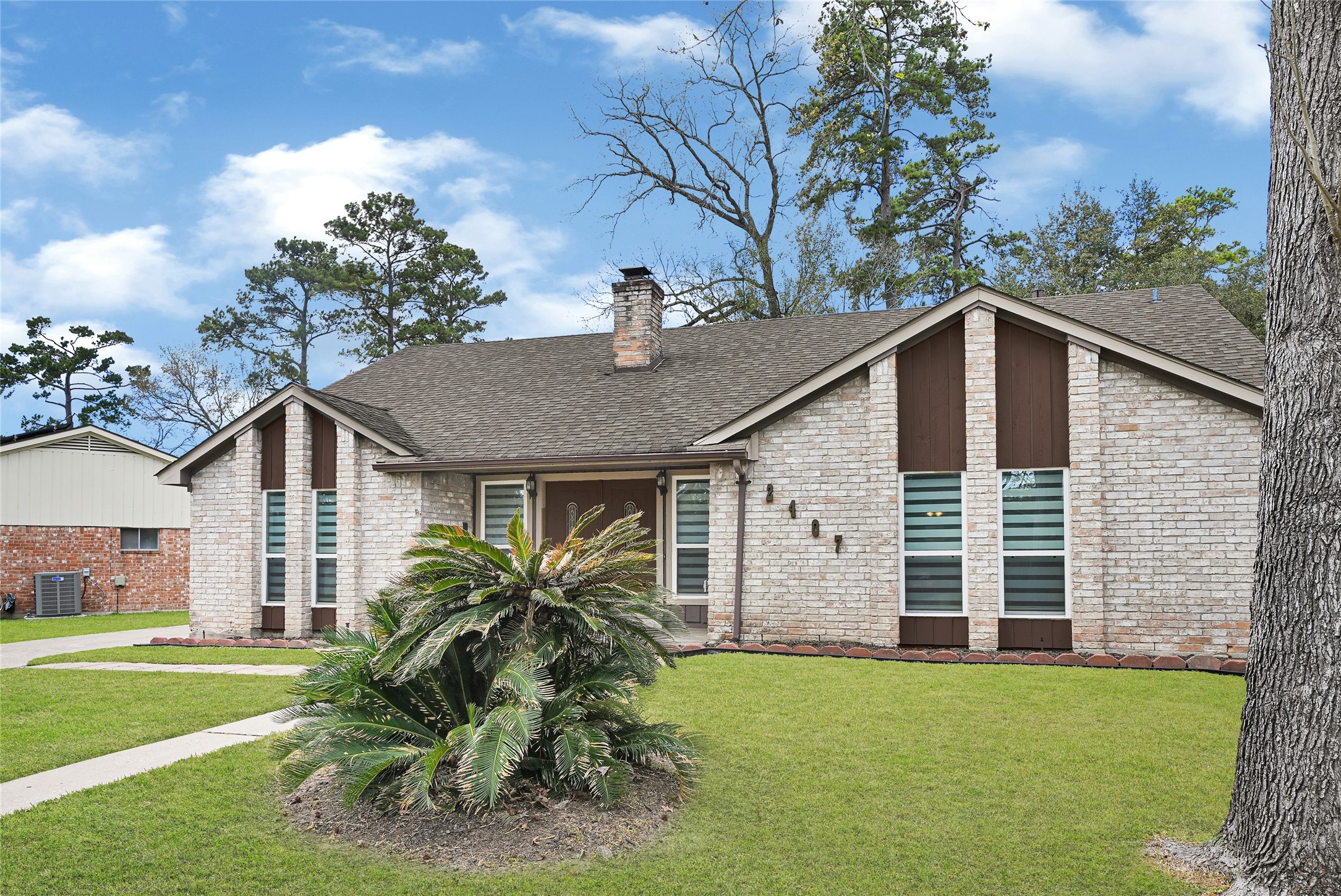 2407 Rambling Brook Drive Spring, TX 77373 - Photo 49 of 49 a view of a yard in front of a house with plants and large tree