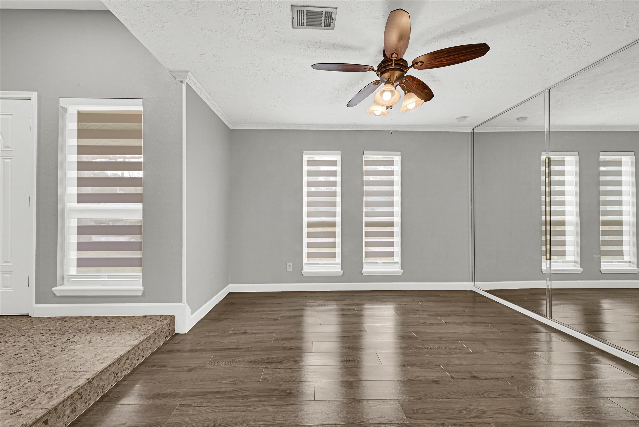 2407 Rambling Brook Drive Spring, TX 77373 - Photo 9 of 49 a view of empty room with wooden floor and fan