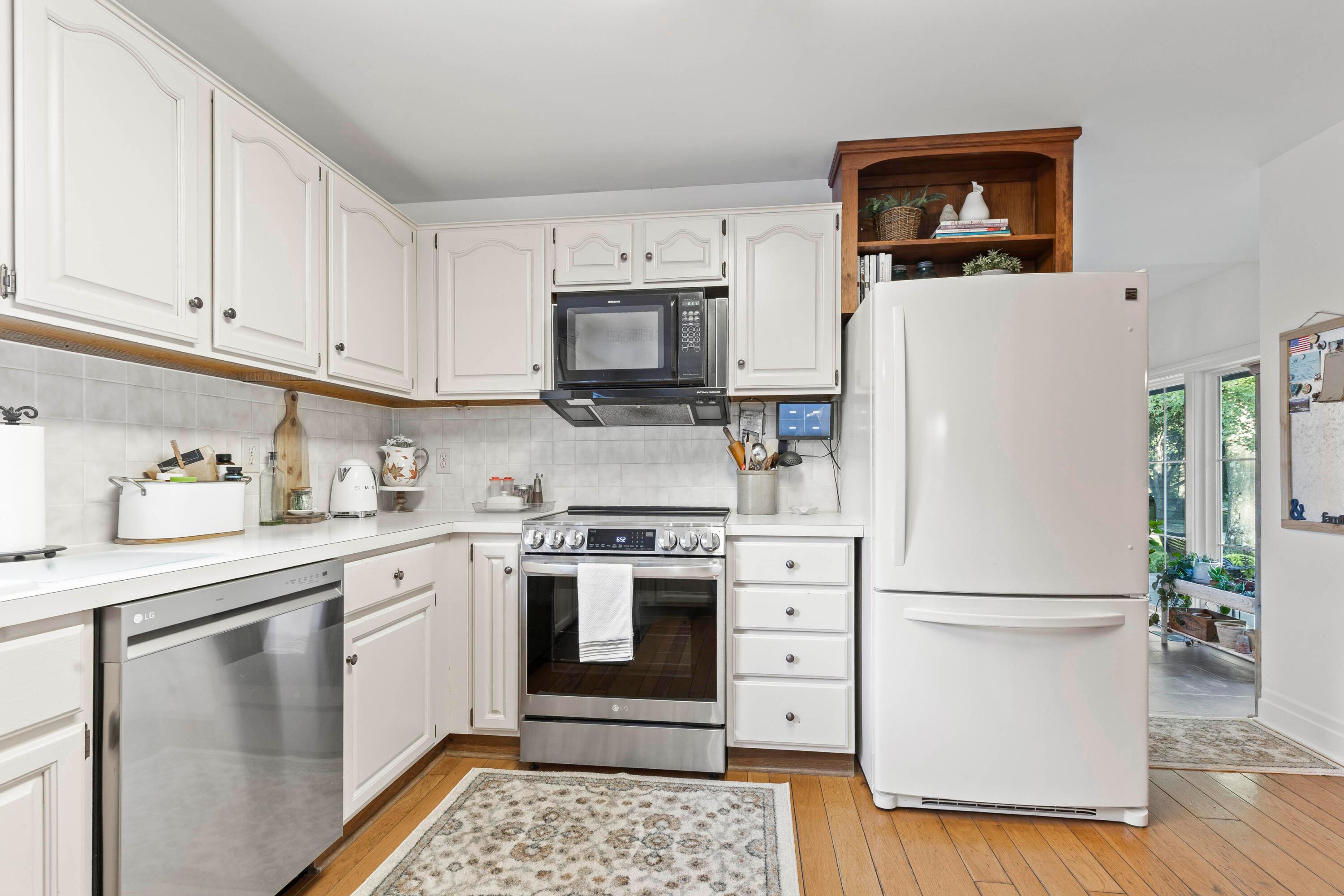 6262 Duffy Road Delaware, OH 43015 - Photo 15 of 96 • Hardwood flooring
• White painted walls
• Raised panel cabinets
• Frigidaire® microwave
• New LG® dishwasher
~ 1/2023
• New LG® electric range
~ 1/2023
(down draft vents out)
• New Kenmore®
refrigerator ~ 2013
• Ceramic tile backsplash
• Double bowl sink
with sprayer
• Disposal
• Ceiling light
• Coat closet
• Opens to sunken
Bonus Room