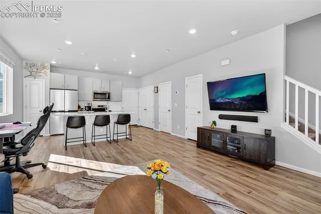 a living room with furniture and a flat screen tv
