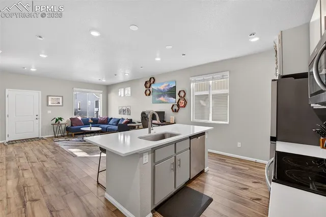 a kitchen with sink refrigerator and cabinets