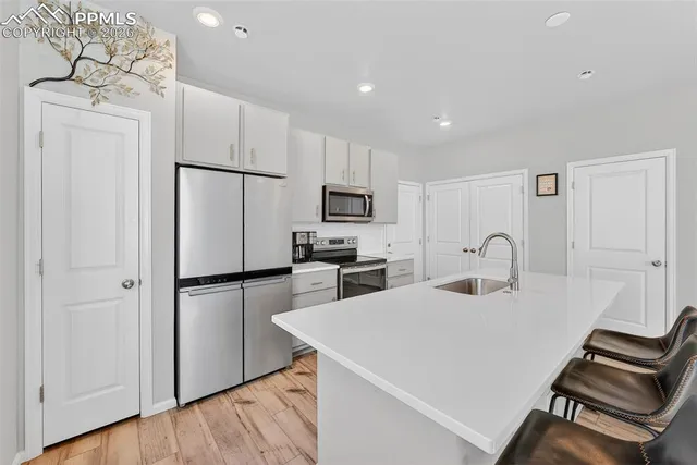a kitchen with a refrigerator a stove top oven a sink and dishwasher