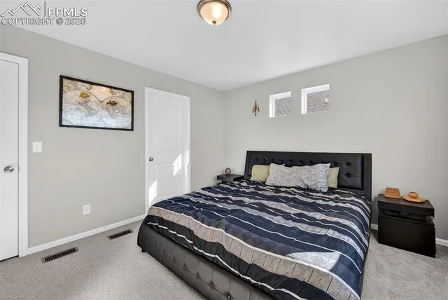 a bedroom with a bed and lamp