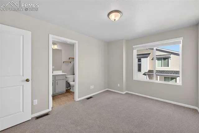 a view of a room that has a large window and closet