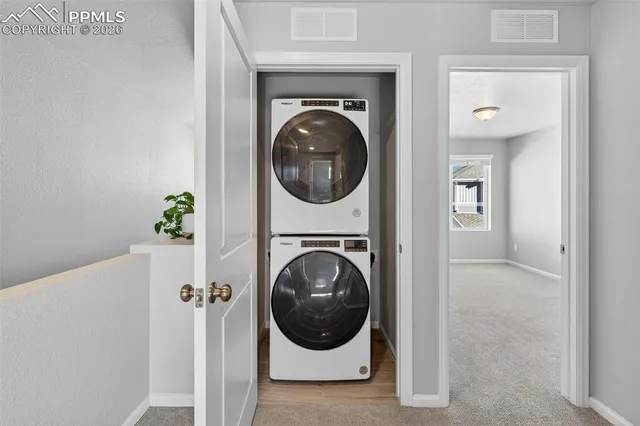 a view of a hallway with washer and dryer