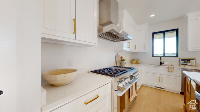 683 North Heritage Street Mapleton, UT 84664 - Photo 12 of 40 Kitchen with wall chimney range hood, range with gas stovetop, light countertops, white cabinets, and recessed lighting