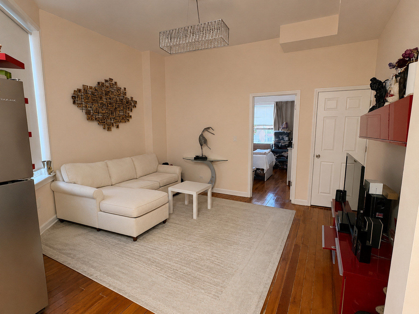 3142 West Cermak Road Chicago, IL 60623 - Photo 5 of 11 a living room with furniture a rug and a flat screen tv