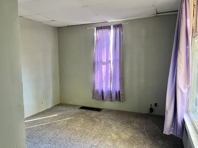 a view of a room with red walls and a window