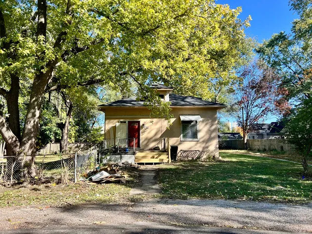 a view of a park with plants and large trees