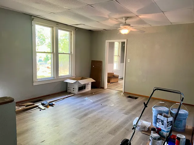 a living room with furniture gym equipment and a large window