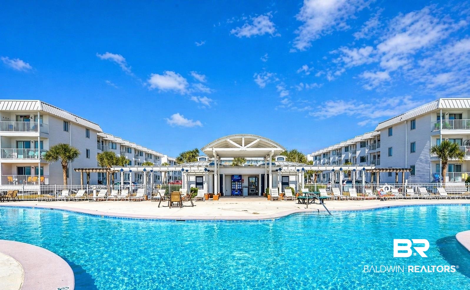 400 Plantation Road, Unit 2118 Gulf Shores, AL 36542 - Photo 30 of 59 Expansive outdoor pool area featuring a large, blue-tiled swimming pool and surrounding paved deck