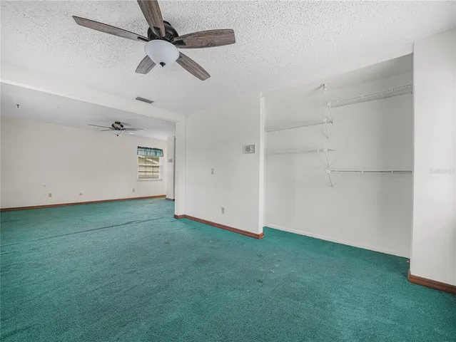 an empty room with a ceiling fan and a ceiling fan