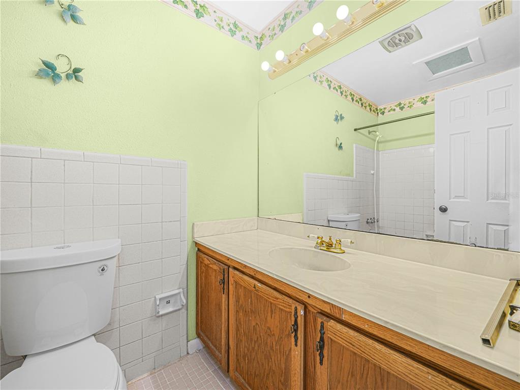 129 Lake Otis Road Winter Haven, FL 33884 - Photo 16 of 35 a bathroom with a sink a toilet and a mirror