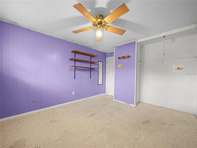 a bathroom with a granite countertop sink a toilet a mirror and shower