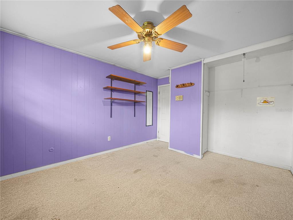 129 Lake Otis Road Winter Haven, FL 33884 - Photo 23 of 35 a view of a livingroom with a ceiling fan and window