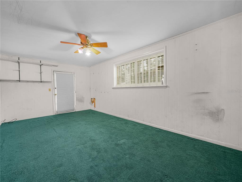 129 Lake Otis Road Winter Haven, FL 33884 - Photo 26 of 35 a view of an empty room with chandelier fan and fire place