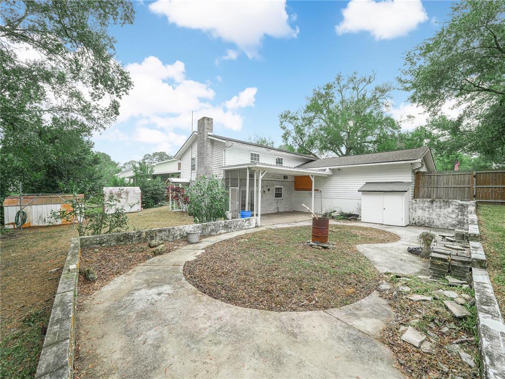129 Lake Otis Road Winter Haven, FL 33884 - Photo 30 of 35 a view of a house with a yard and garage