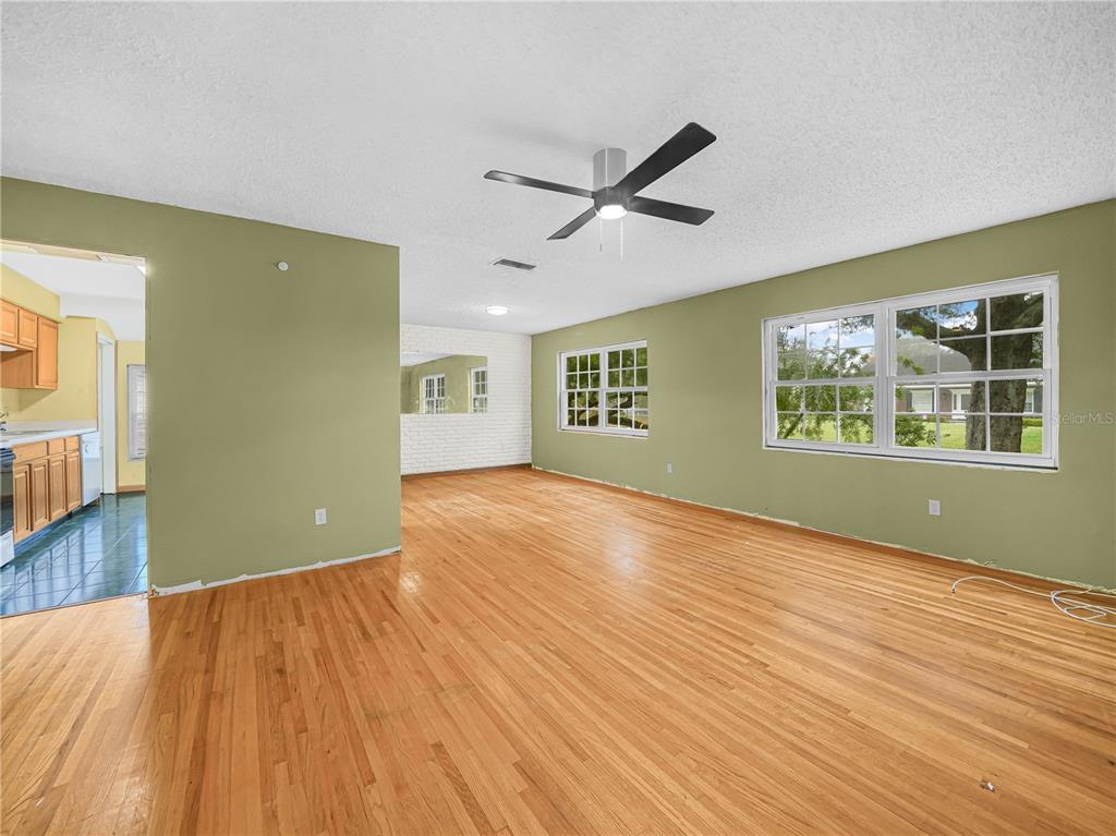 129 Lake Otis Road Winter Haven, FL 33884 - Photo 3 of 35 a view of an empty room with wooden floor and a window