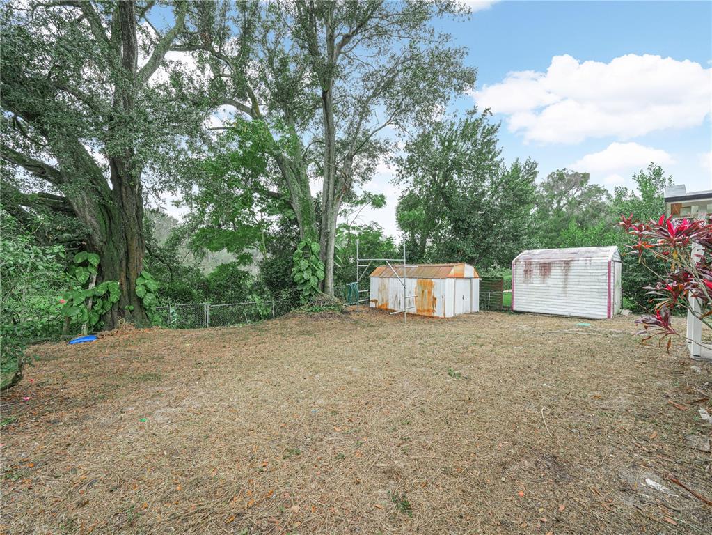129 Lake Otis Road Winter Haven, FL 33884 - Photo 31 of 35 a backyard of a house with oven and outdoor seating