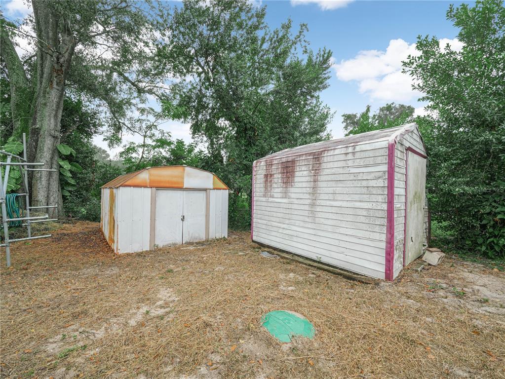 129 Lake Otis Road Winter Haven, FL 33884 - Photo 32 of 35 a view of a small house with a fence and a tree