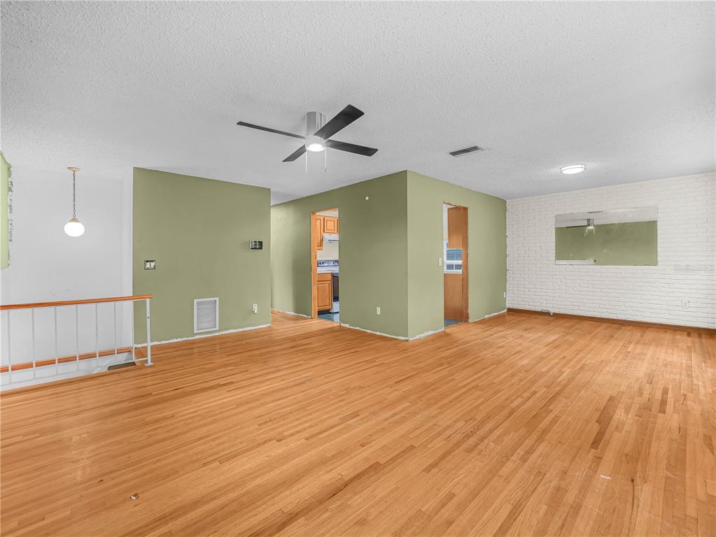 129 Lake Otis Road Winter Haven, FL 33884 - Photo 4 of 35 a view of an empty room with wooden floor and a window