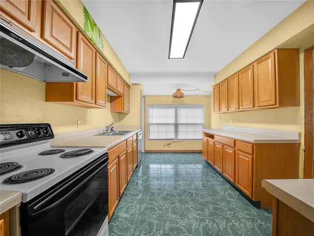 a kitchen with stainless steel appliances granite countertop a stove and a sink