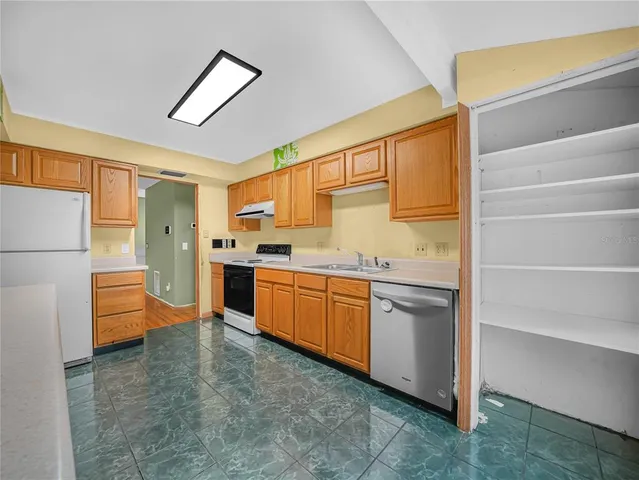 a kitchen with stainless steel appliances a refrigerator and cabinets