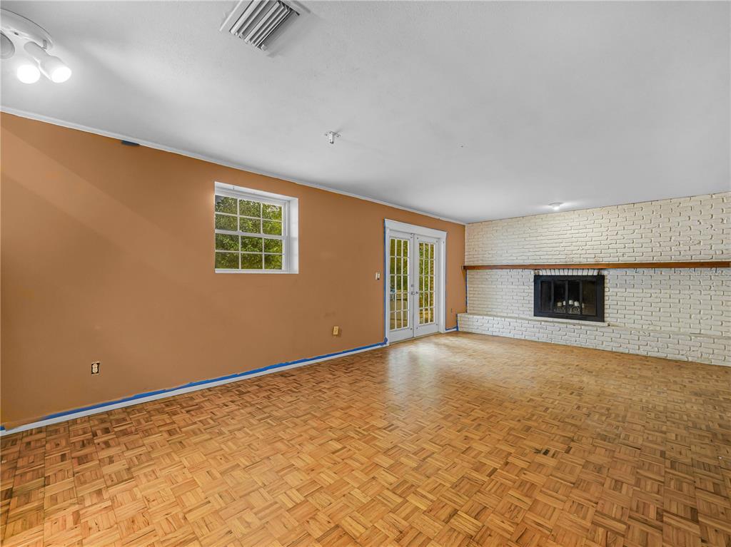 129 Lake Otis Road Winter Haven, FL 33884 - Photo 10 of 35 a view of an empty room with a window and fireplace