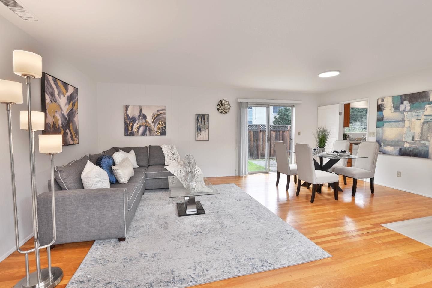10326 Cherry Tree Lane Cupertino, CA 95014 - Photo 12 of 32 a living room with furniture and a dining table with wooden floor