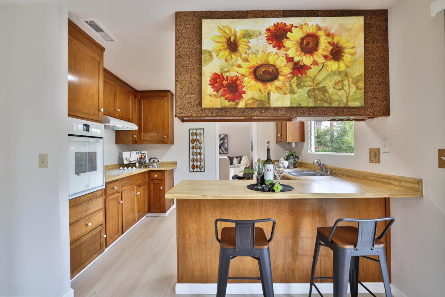 10326 Cherry Tree Lane Cupertino, CA 95014 - Photo 18 of 32 a view of a dining room with furniture a kitchen and wooden floor