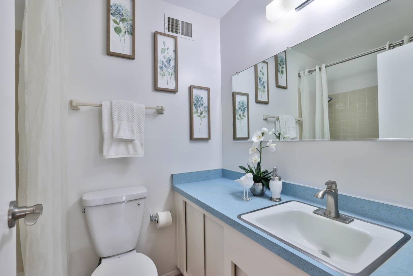 10326 Cherry Tree Lane Cupertino, CA 95014 - Photo 21 of 32 a bathroom with a toilet sink and mirror