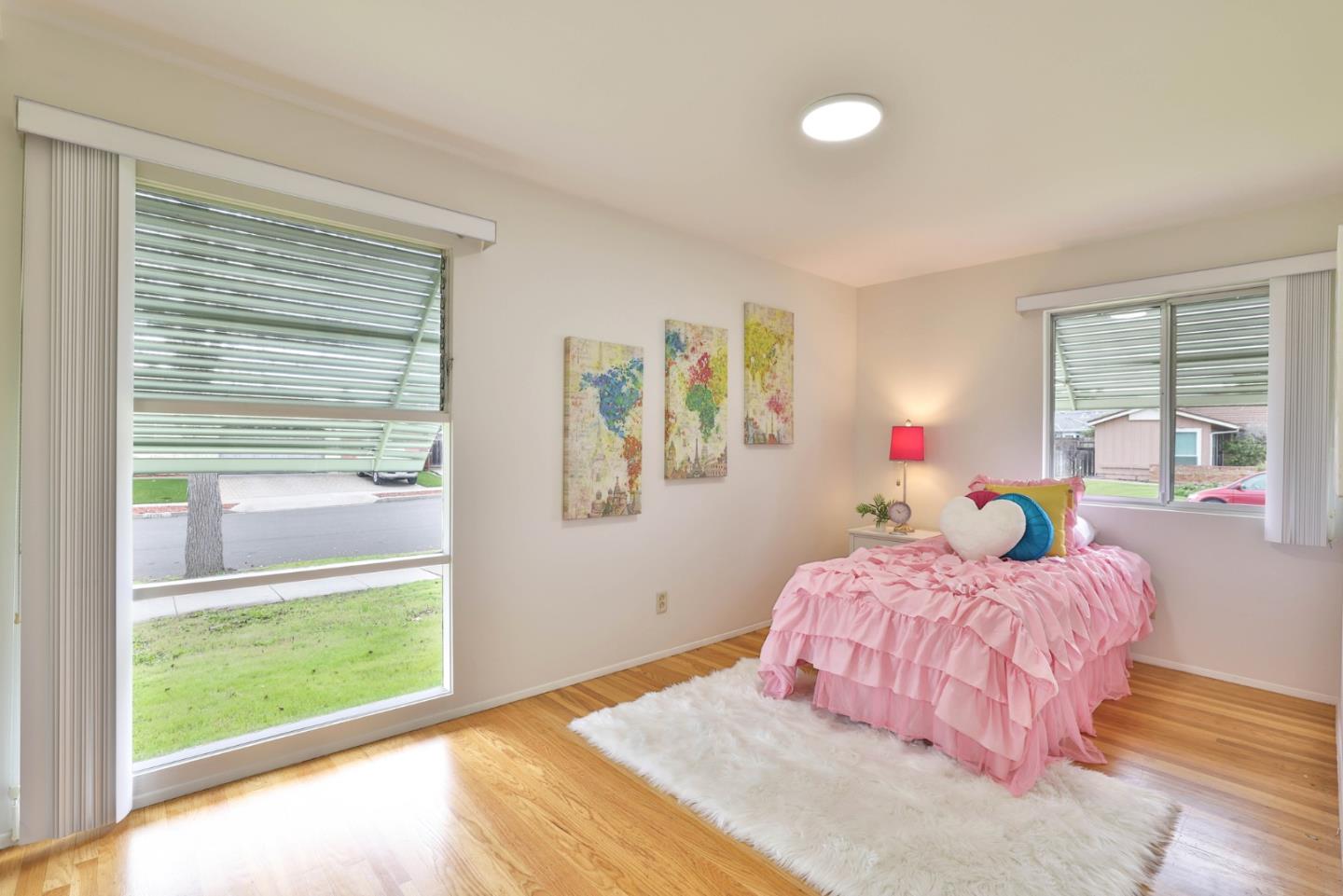 10326 Cherry Tree Lane Cupertino, CA 95014 - Photo 23 of 32 a bedroom with a bed and a large window