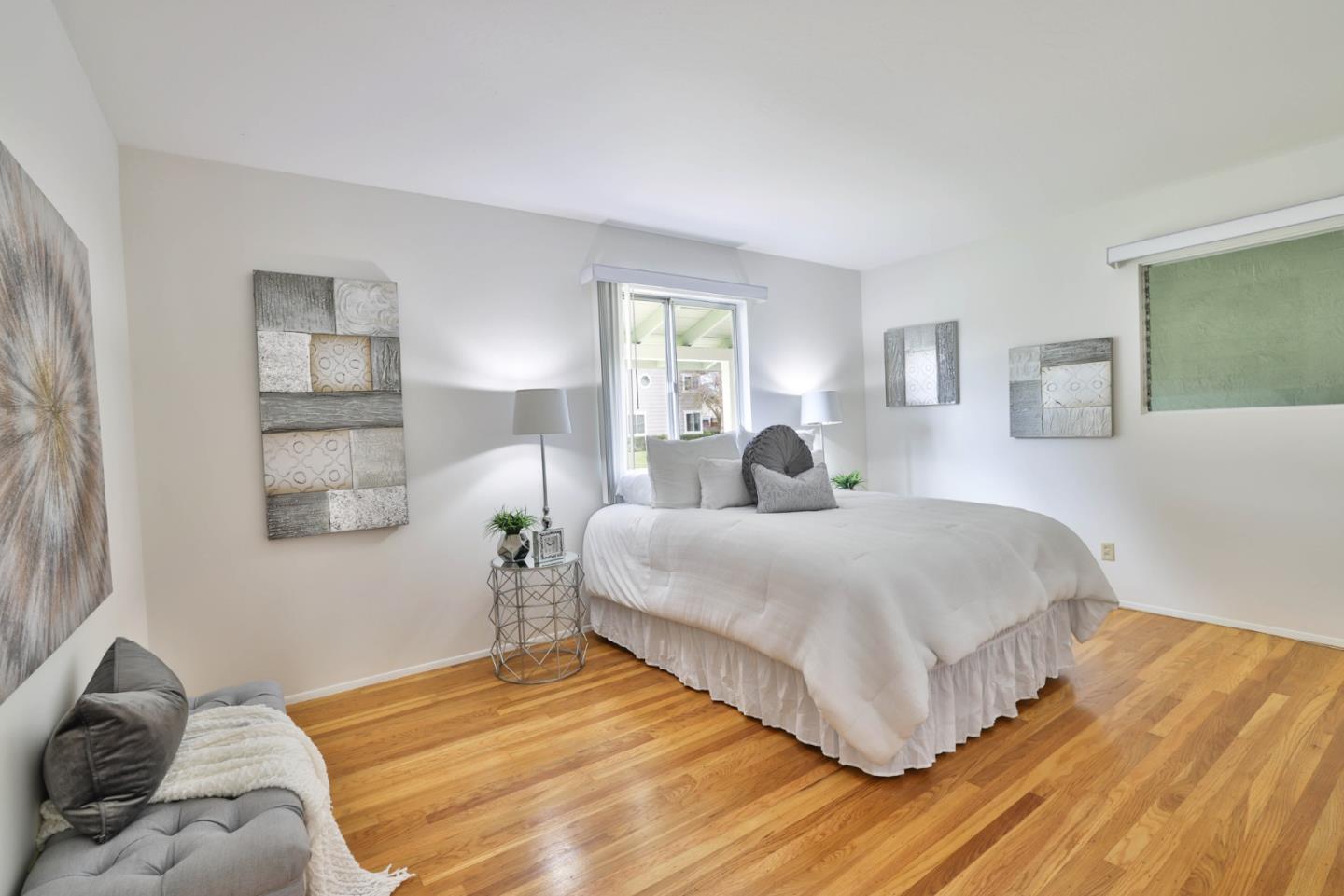 10326 Cherry Tree Lane Cupertino, CA 95014 - Photo 24 of 32 a bedroom with a bed and wooden floor