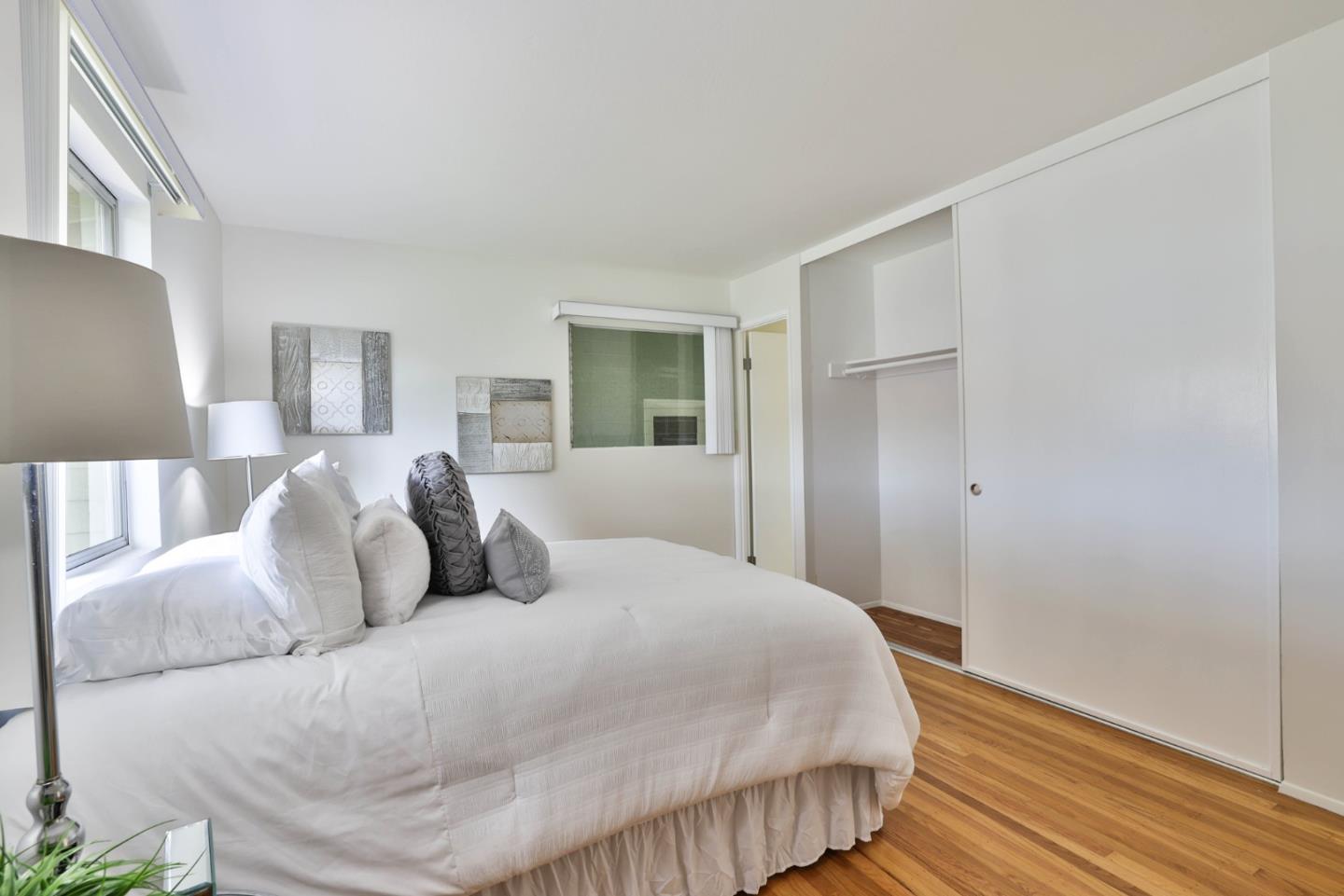 10326 Cherry Tree Lane Cupertino, CA 95014 - Photo 25 of 32 a large bed sitting in a bedroom and a table