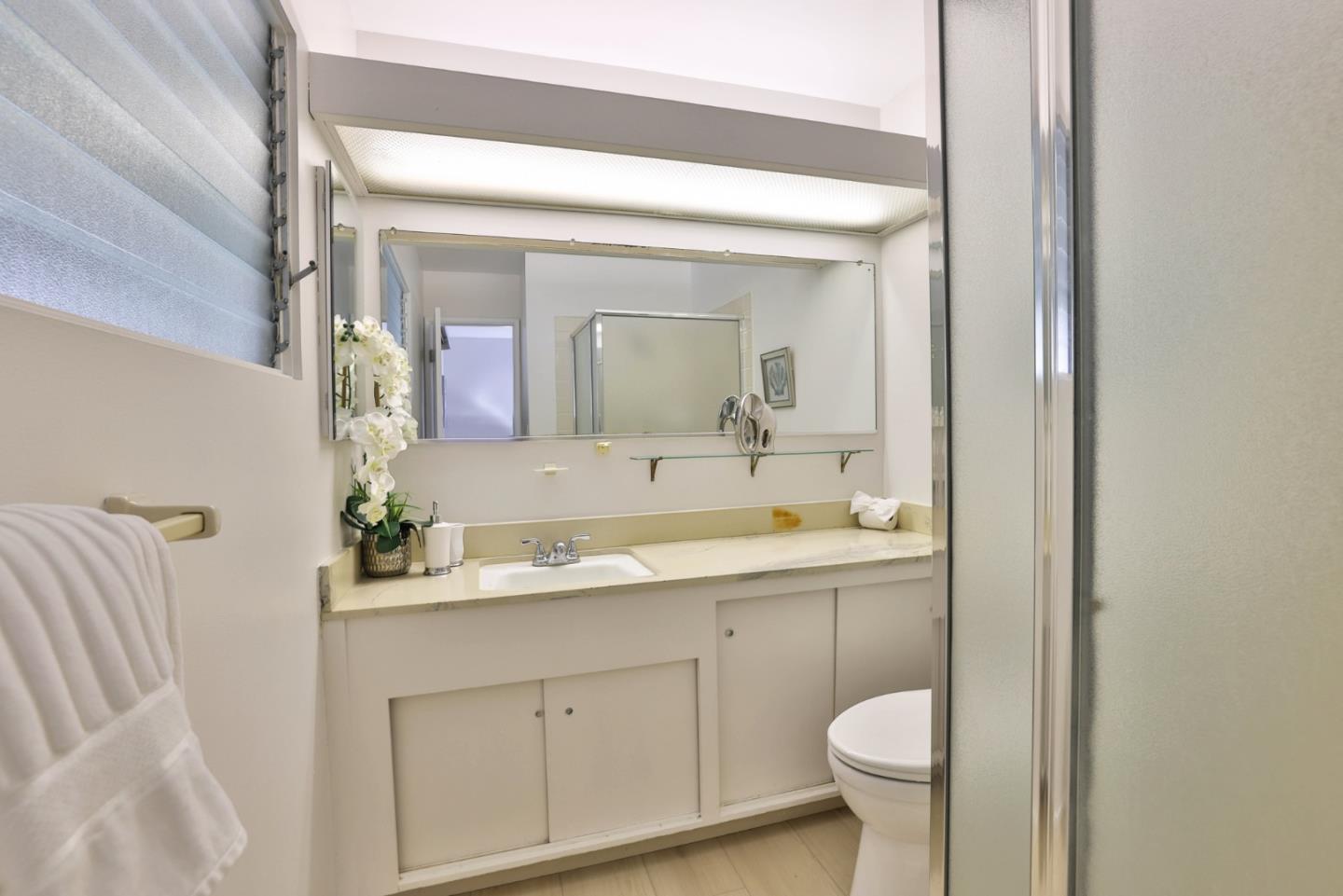 10326 Cherry Tree Lane Cupertino, CA 95014 - Photo 26 of 32 a bathroom with a toilet sink and mirror
