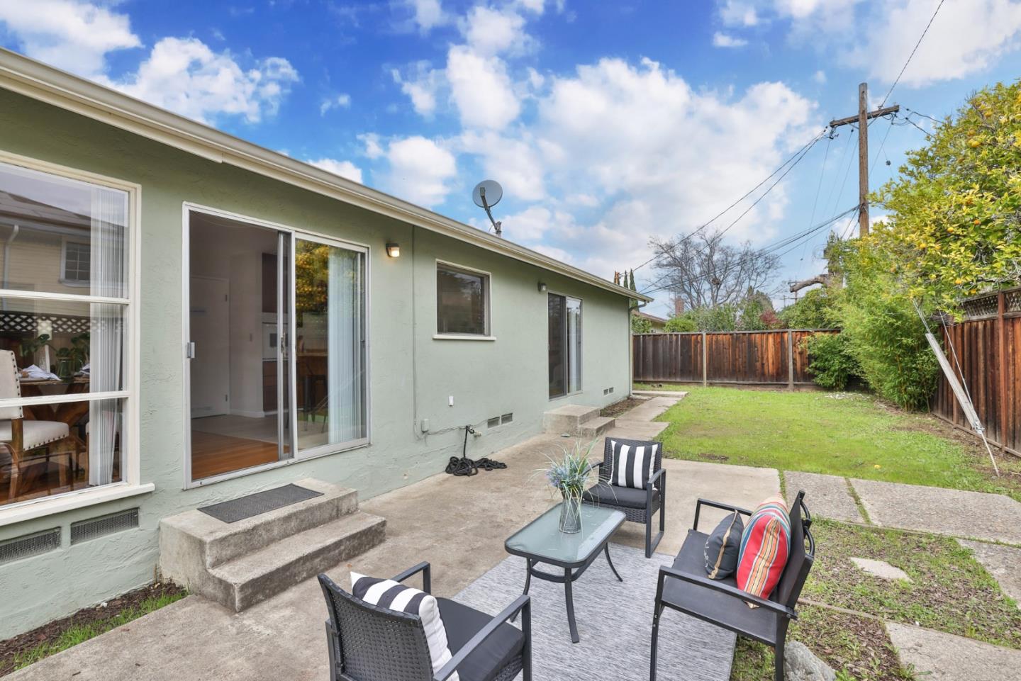 10326 Cherry Tree Lane Cupertino, CA 95014 - Photo 31 of 32 a patio with table and chairs and potted plants