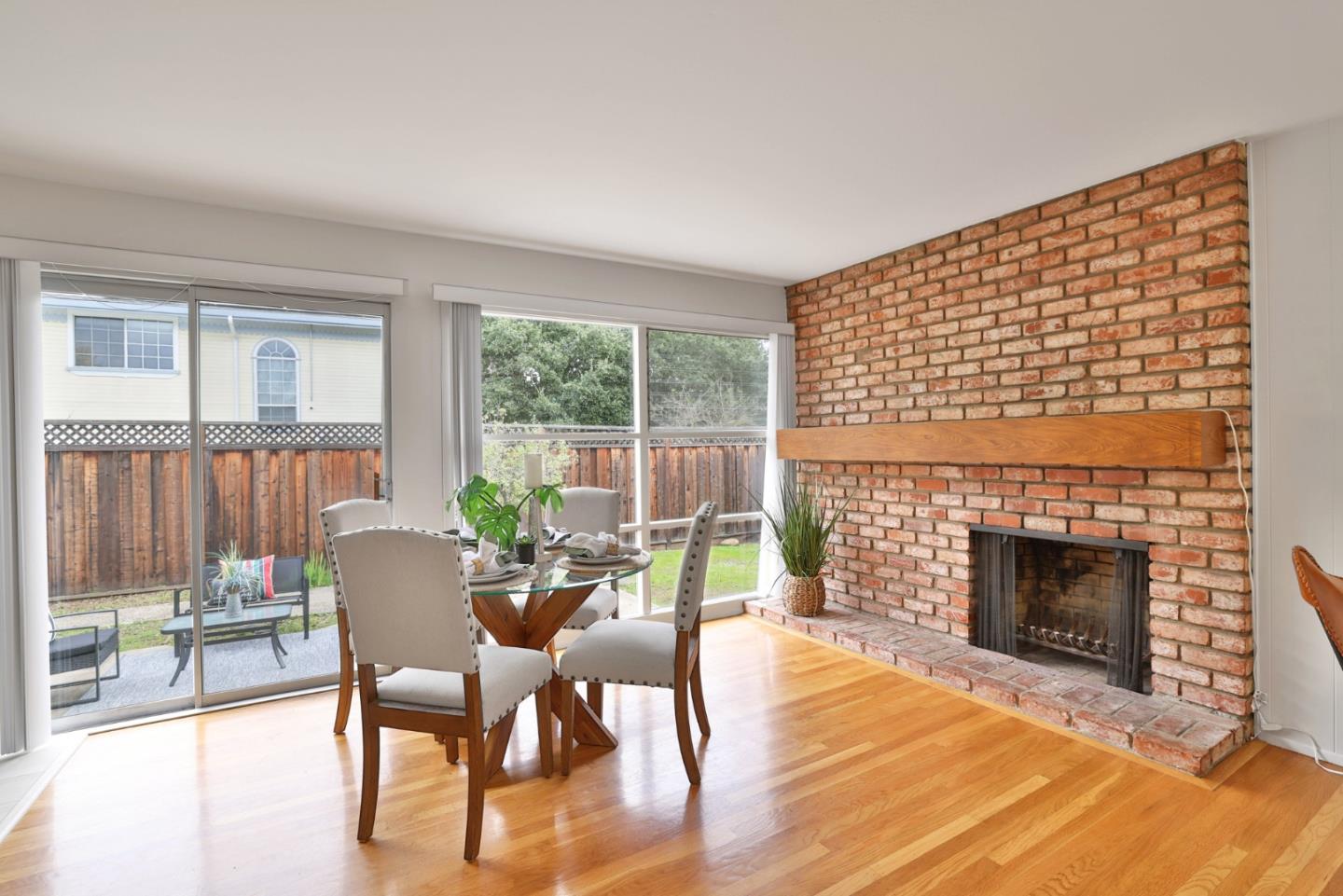 10326 Cherry Tree Lane Cupertino, CA 95014 - Photo 6 of 32 a dining room with furniture a fireplace and wooden floor