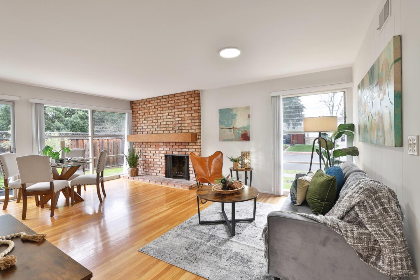 10326 Cherry Tree Lane Cupertino, CA 95014 - Photo 7 of 32 a living room with furniture and a fireplace