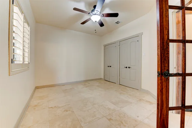 a view of a living room a kitchen and a chandelier fan