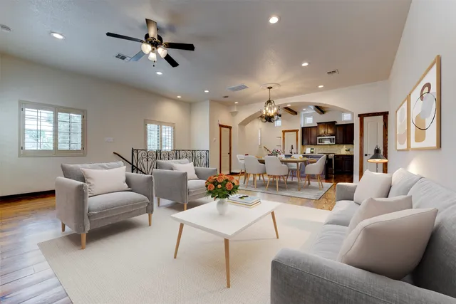 a view of empty room with wooden floor and windows