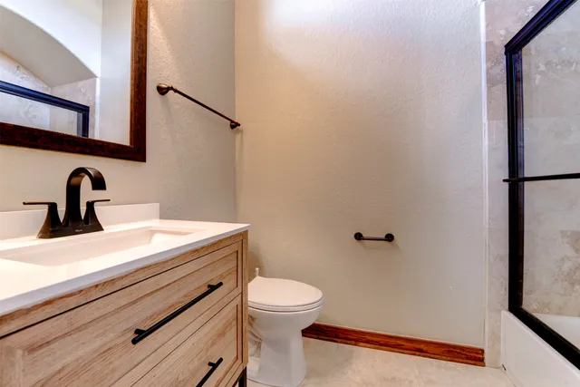 a bathroom with a glass shower door