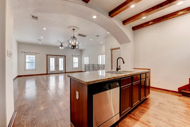 a spacious bathroom with a granite countertop sink a large mirror and vanity