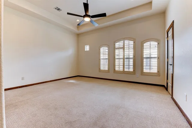 a view of empty room with ceiling fan