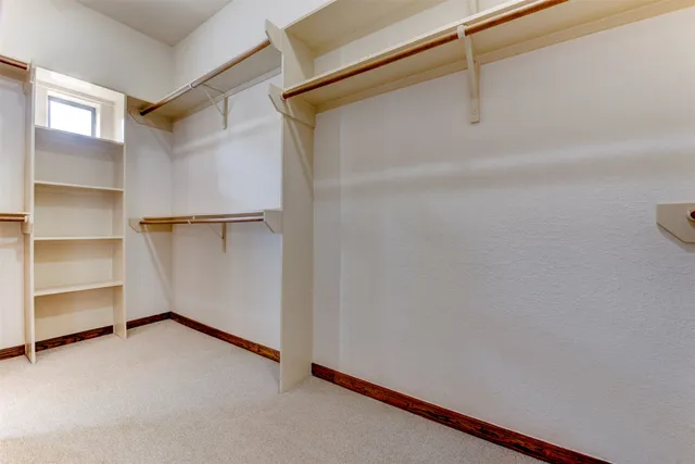 a bathroom with a tub a double vanity sink and mirror